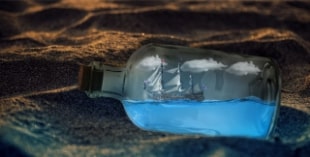a pirate ship encased in a bottle laying on a sunset-licked beach